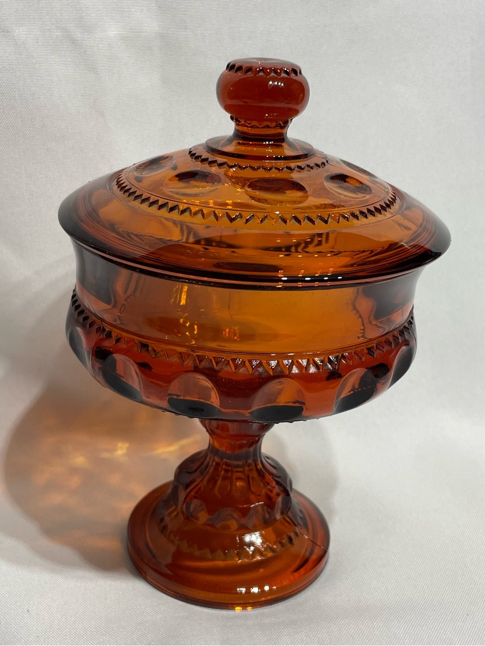 Vintage Indiana Glass 7.5” amber lidded candy dish in the Kings Crown thumbprint